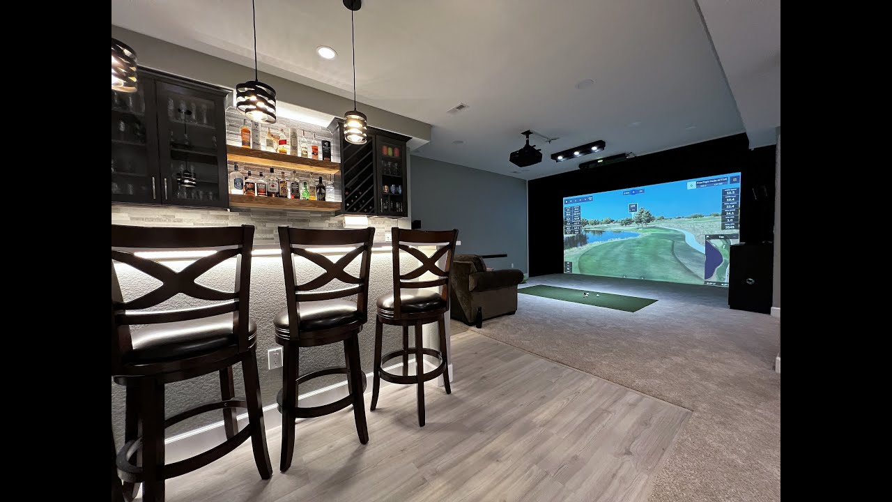 Golf Simulator in a Basement with hitting mat custom inserted within the existing carpet