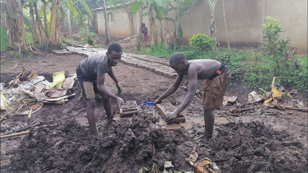 Poor Africanvillage boys make bricks to earn money that will help  obtain back to school basic needs