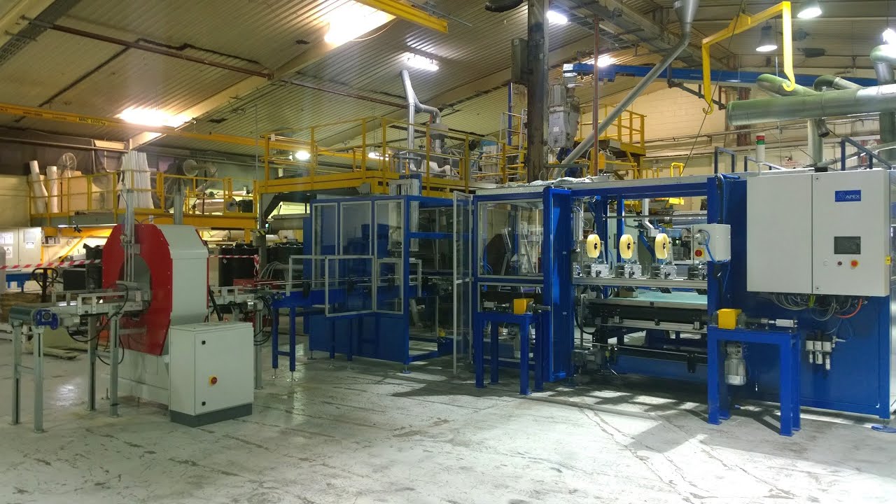 Automation system for rolling and taping foam sheets with spiral wrapping machine