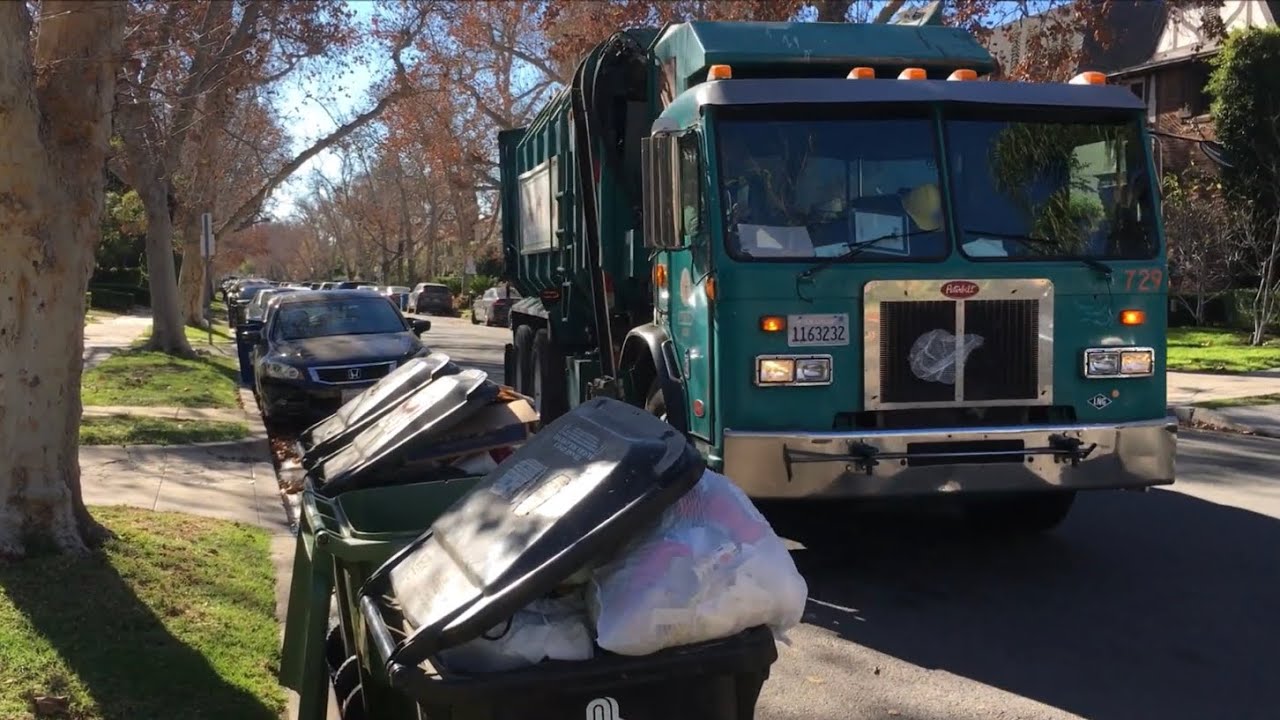 LA Amrep Automated Garbage Truck on Overloaded Holiday Trash