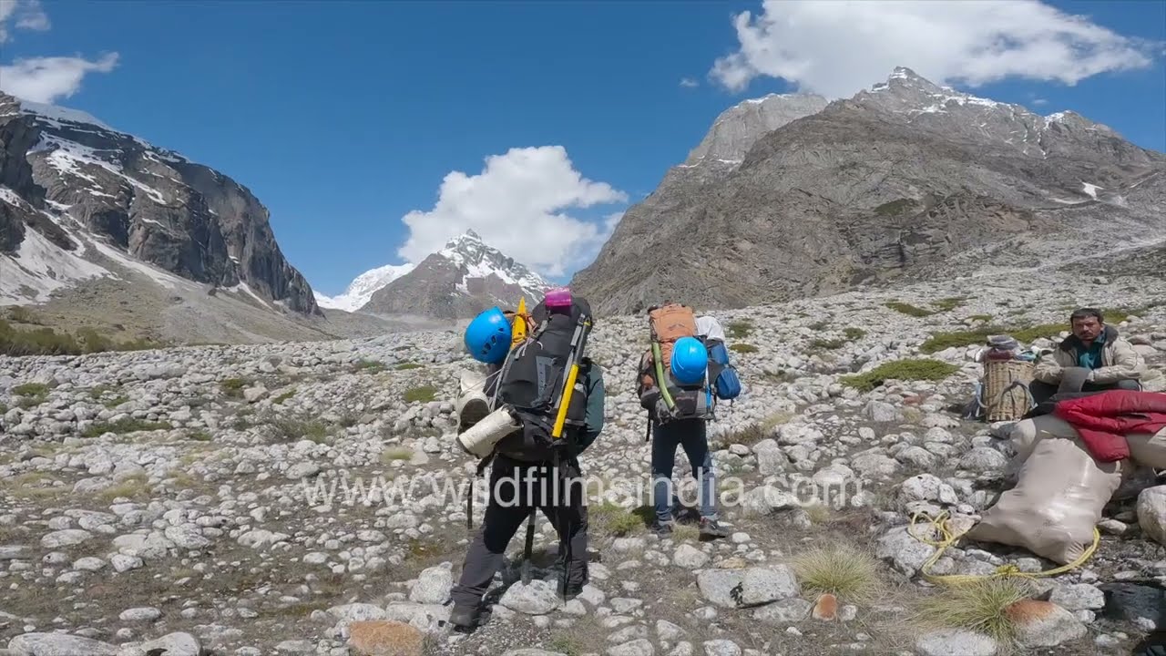 Chaukhamba col expedition crossing glacial moraine and fast flowing torrent in Garhwal Himalaya