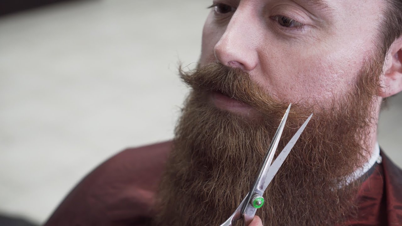 Beard Barber Trims and Shapes a Big Beard and Handlebar Mustache