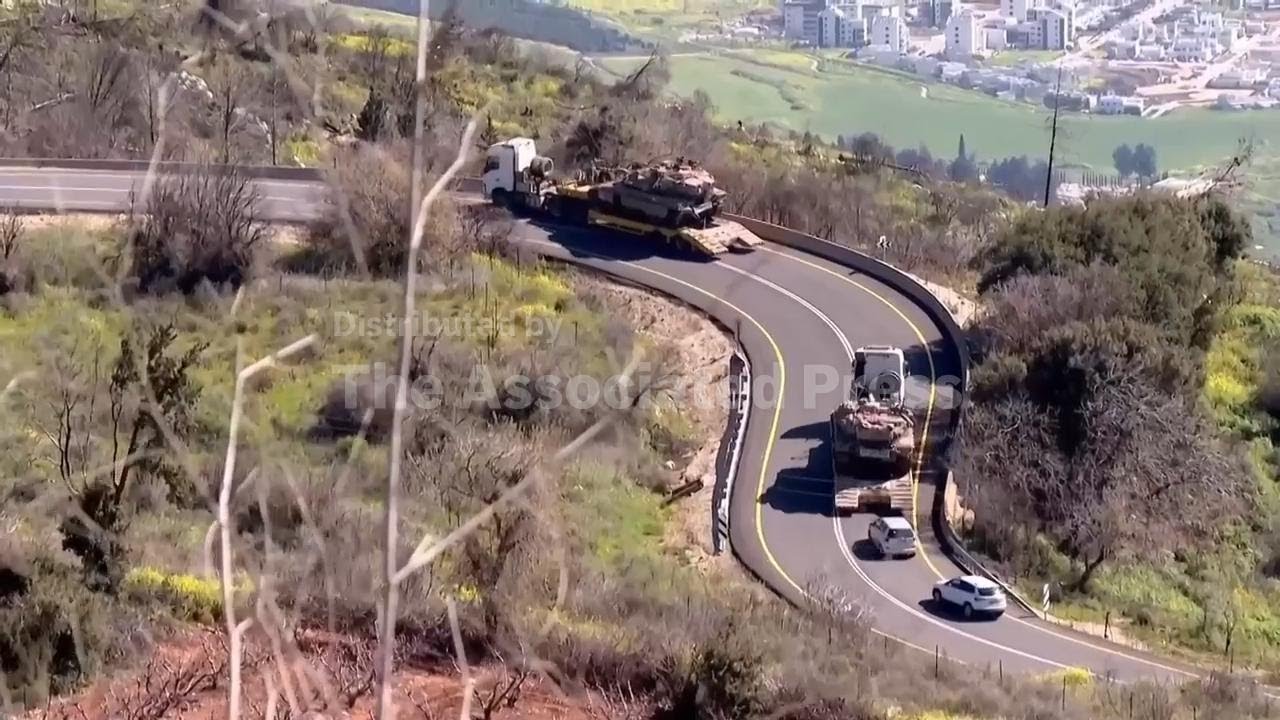 Israeli tanks move to Lebanon border as fighting escalates