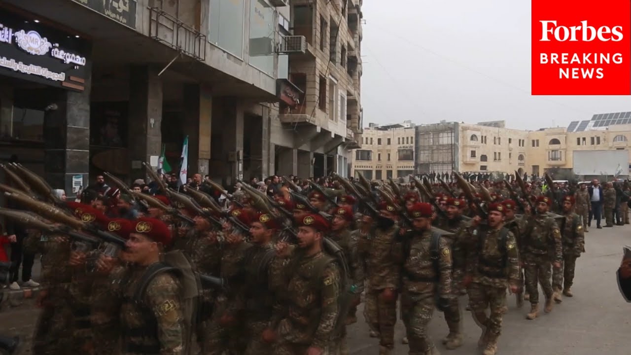 Thousands Of Syrian Soldiers March To Commemorate One-Year Anniversary Of Assad Regime's Fall