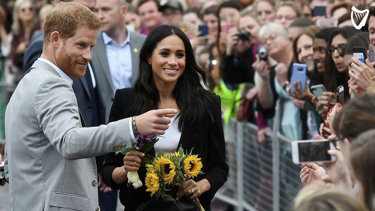 Fans shower Meghan Markle with flowers at Trinity College