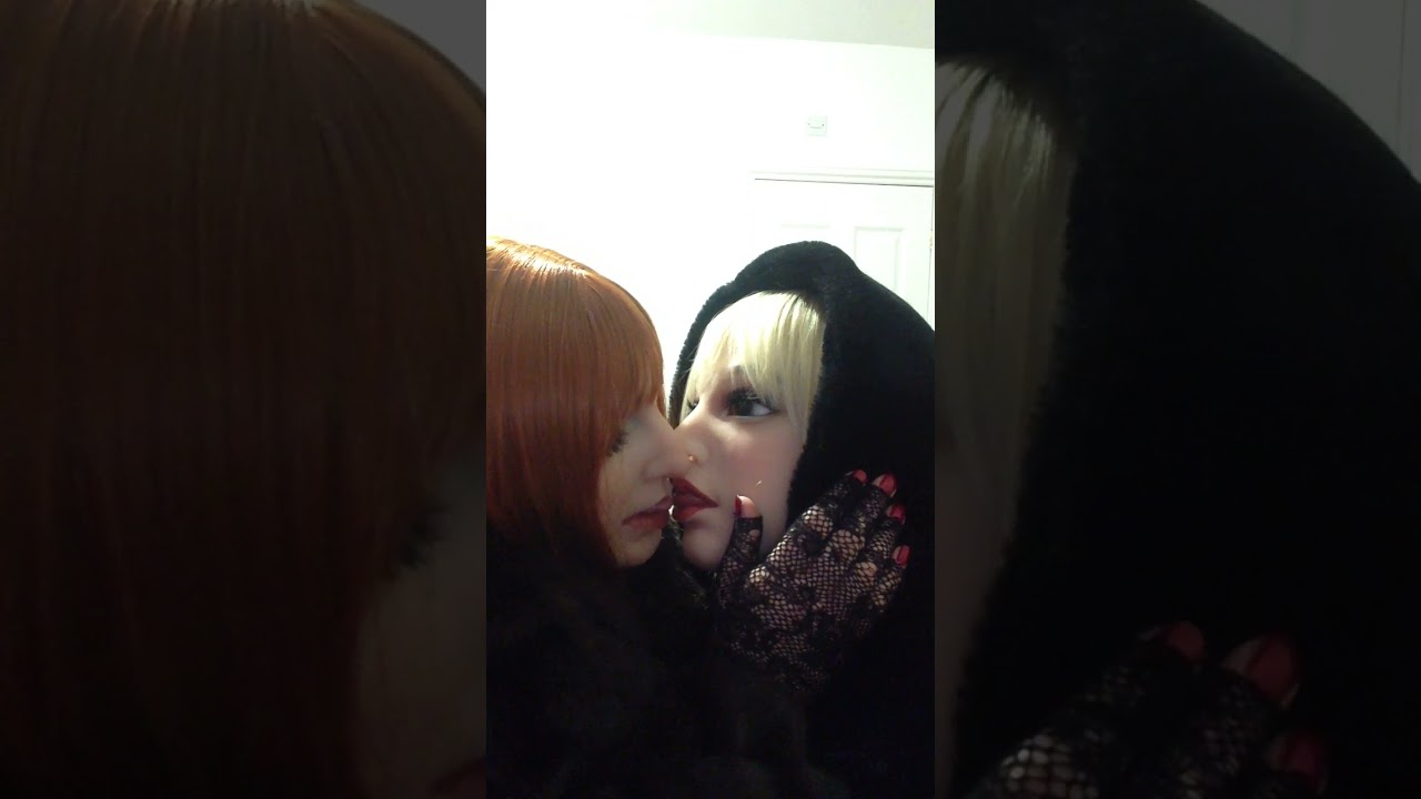 Me & my partner kissing whilst wearing female silicone masks & fur coats.