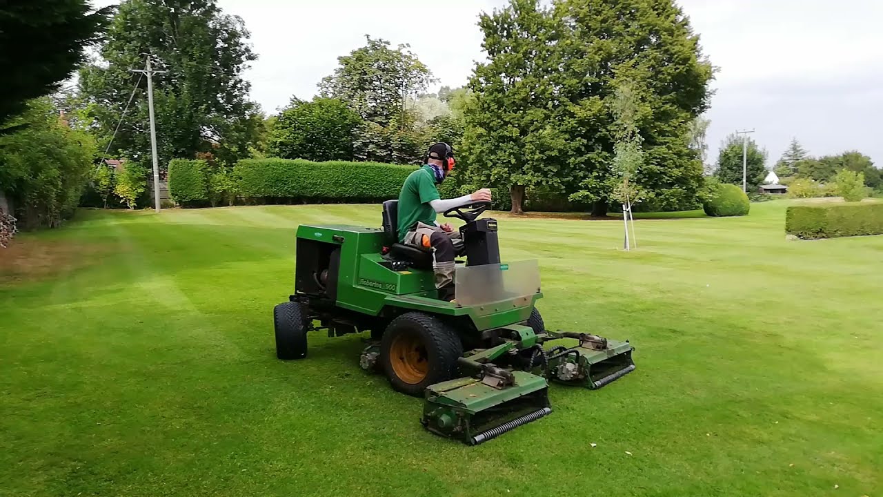 Lawn Mowing Low cut Lawn with a TRIPLE  Reel Mower