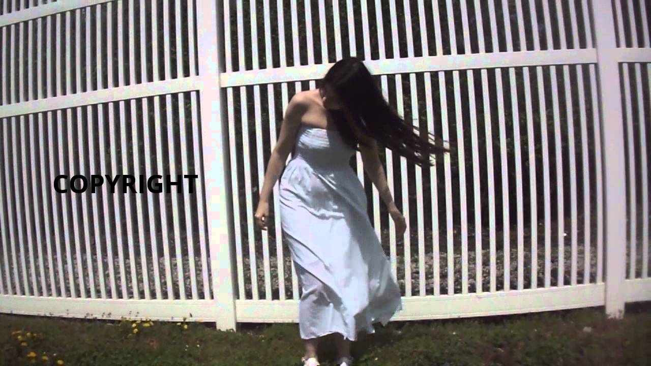 Woman Standing In The Wind With Blowing Long Dress And Hair