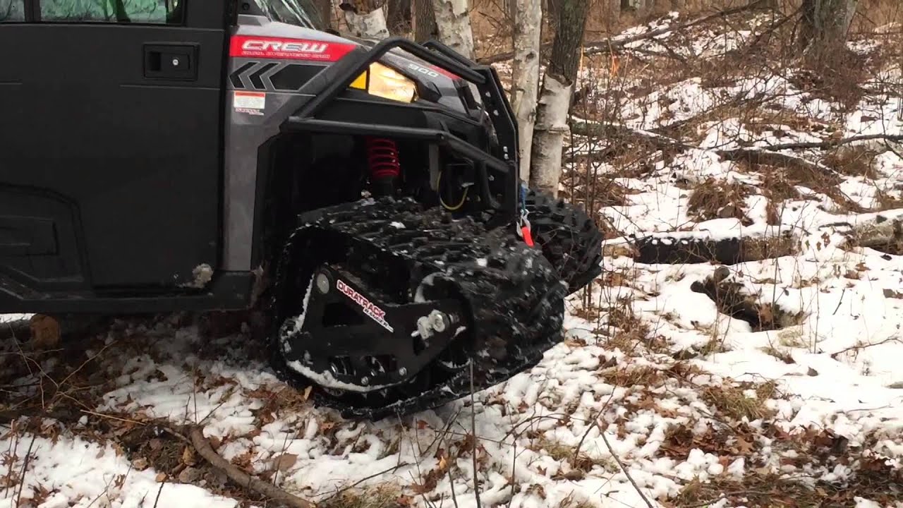 Polaris RANGER 900 Crew on DURATARCKS going through woods. RANGER Track System