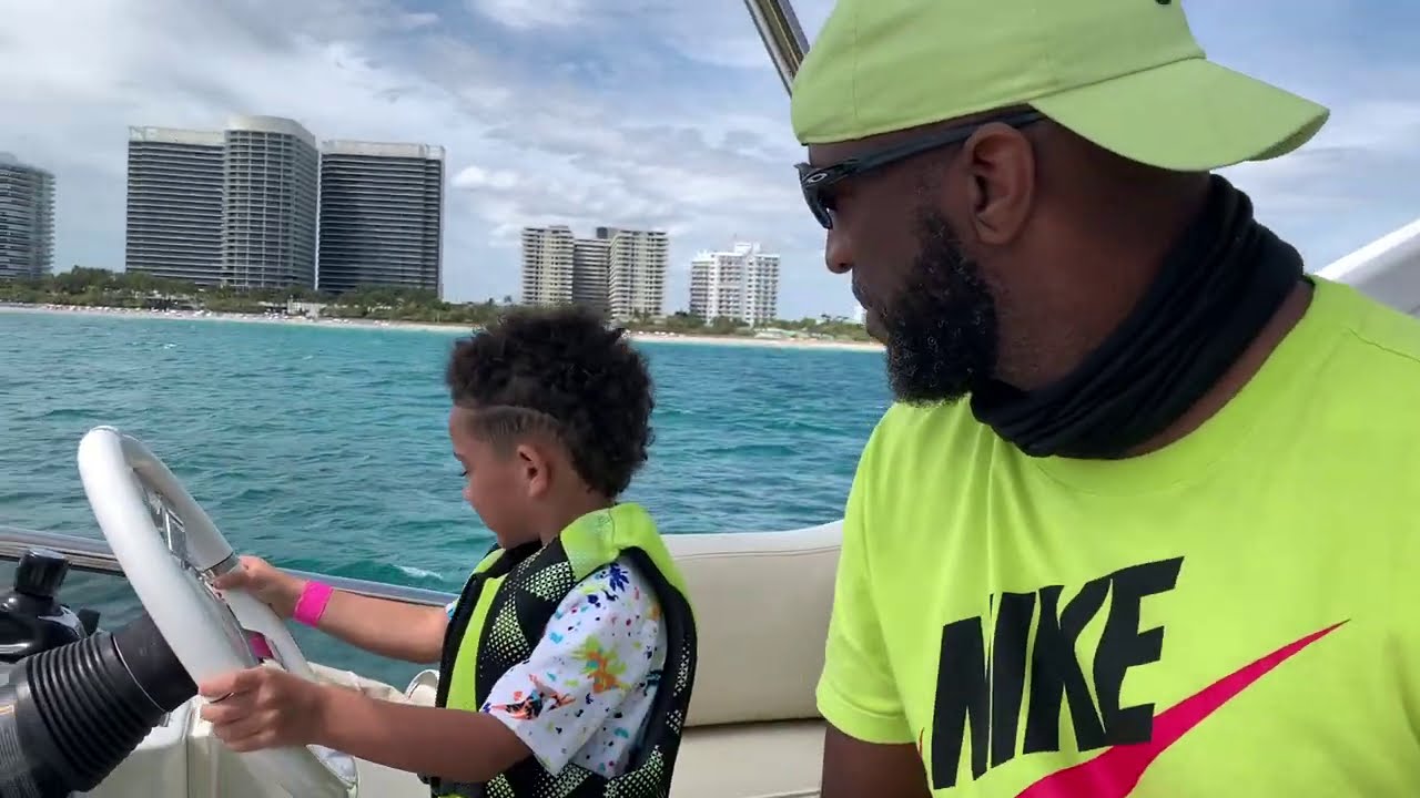 Teaching My Grandson To Steer A Boat