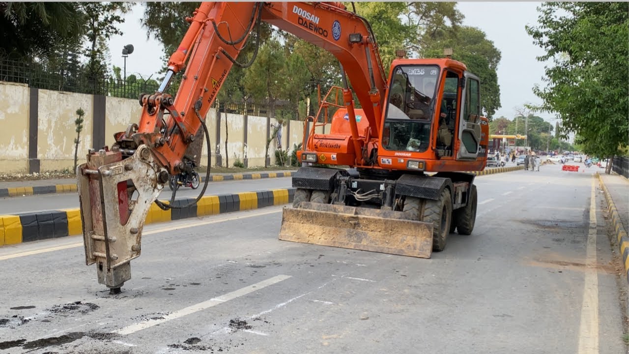 Excavator Going To Pipe Line Work In The Road Centre