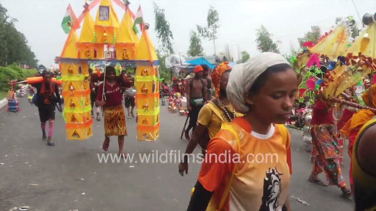 Devotees walk steadily along the highway during the sacred Kanwar Yatra: Haridwar