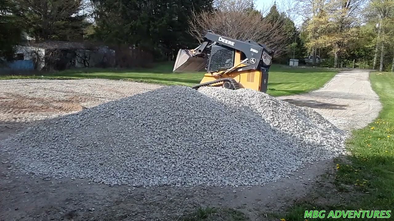Leveling out a Gravel Driveway using a Skid Steer Land Leveler and adding more material!