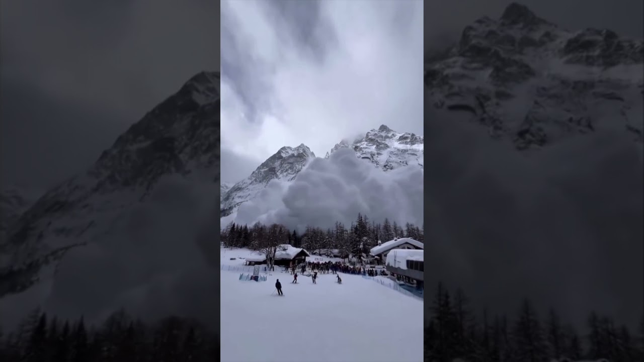 Moment avalanche rushes down Alps mountain as skiers watch on