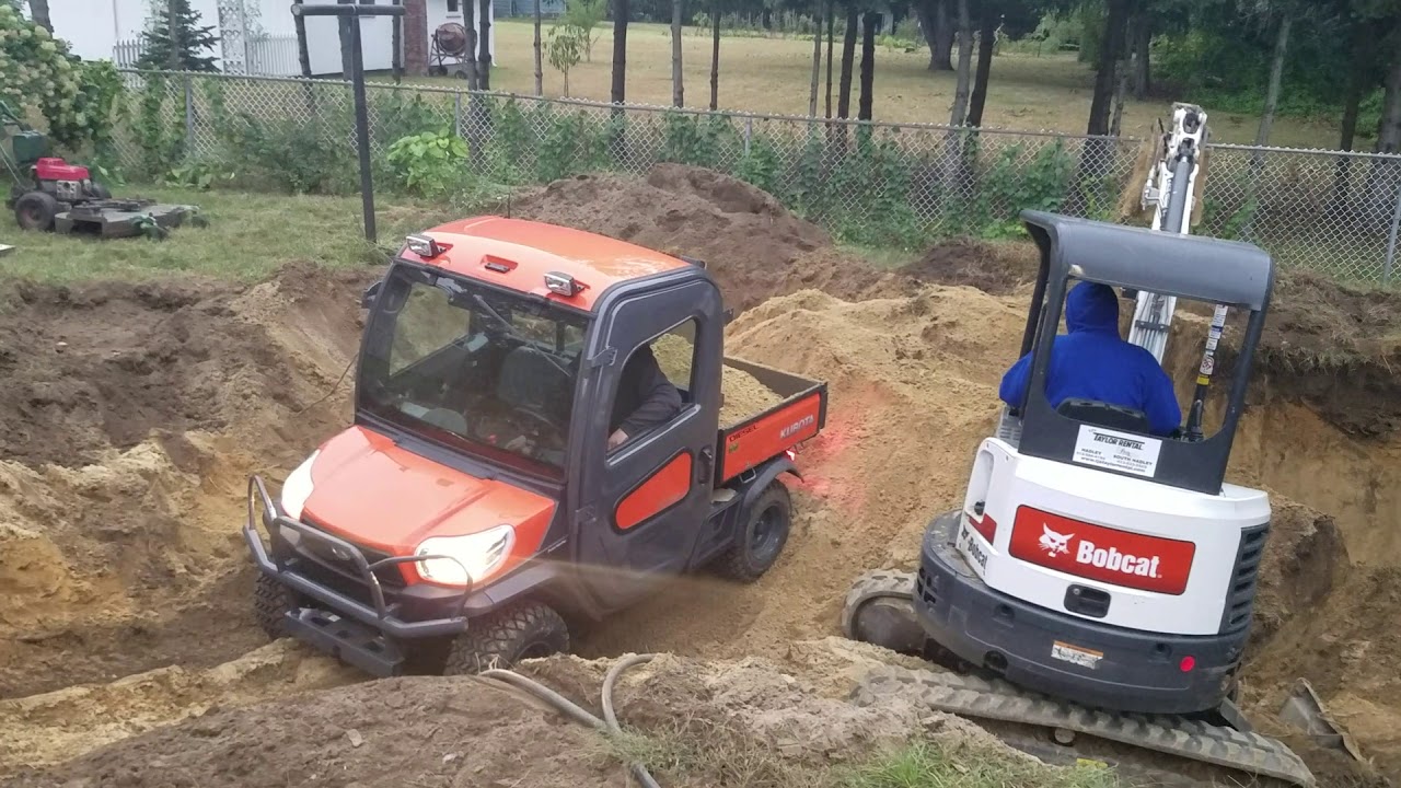 Kubota rtv x1100c being loaded with fill