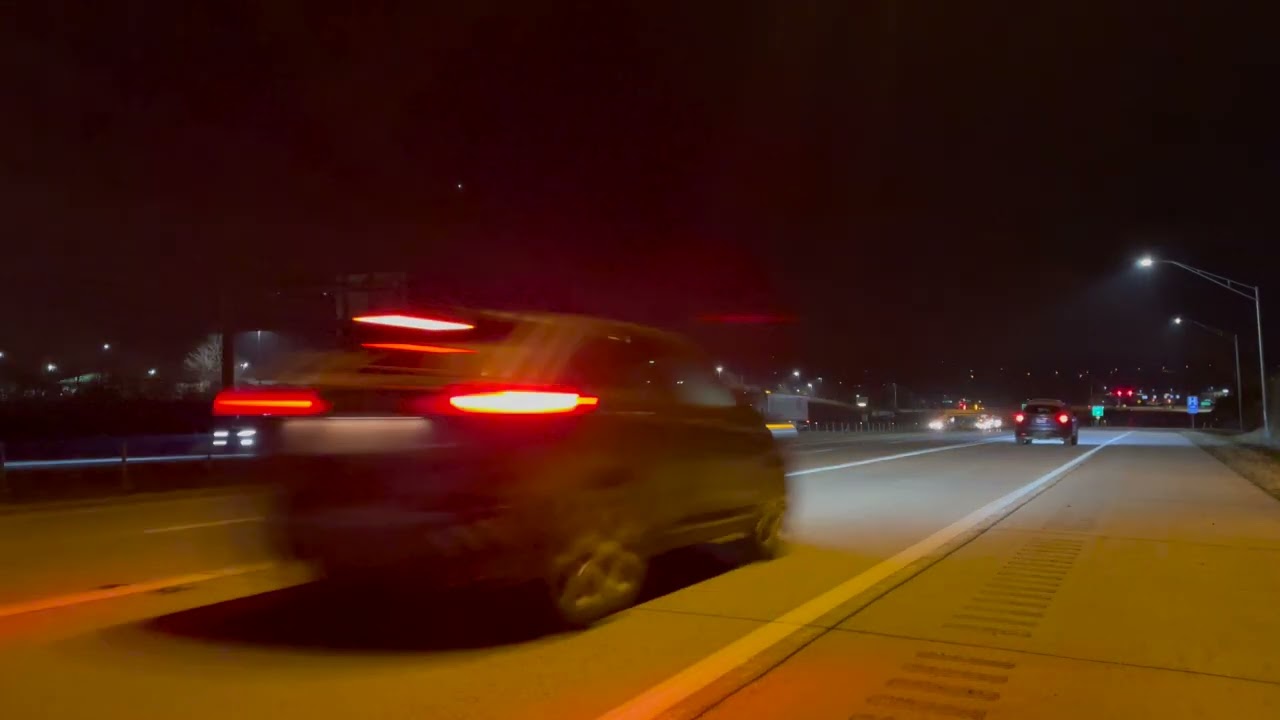 Cars and trucks passing by on the road at night