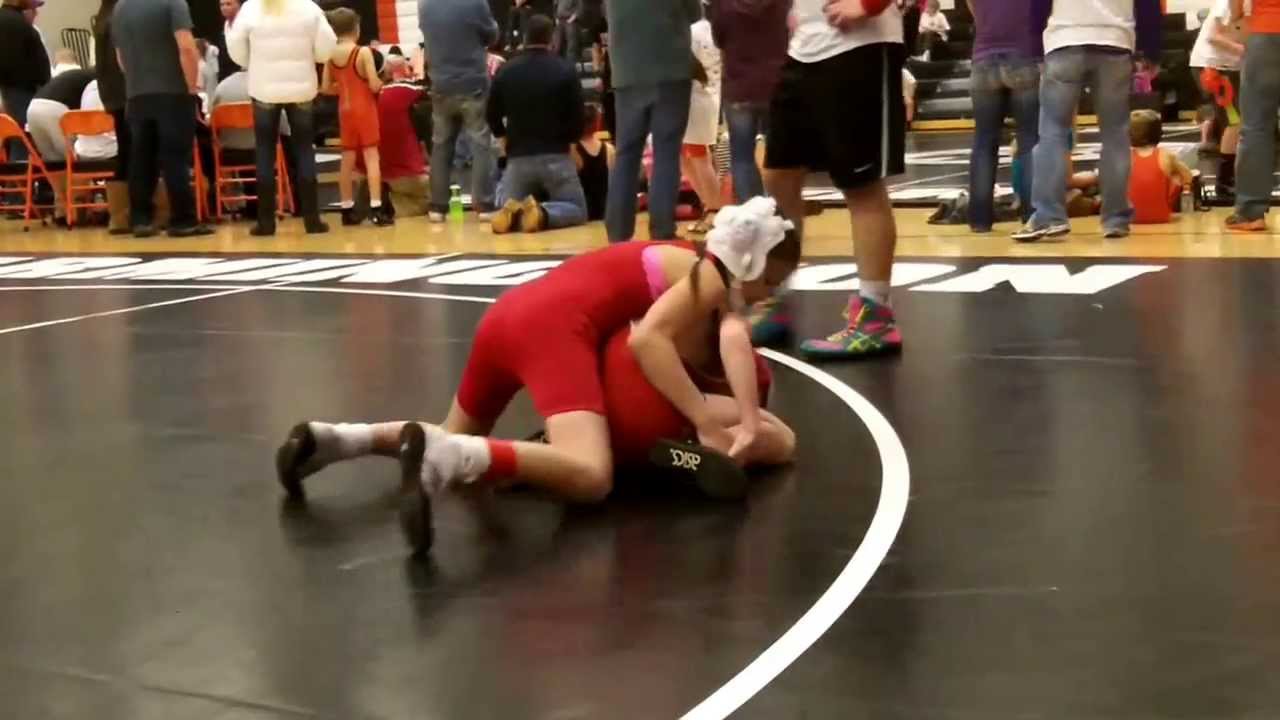 Girl youth wrestler winning and pinning in her wrestling matches