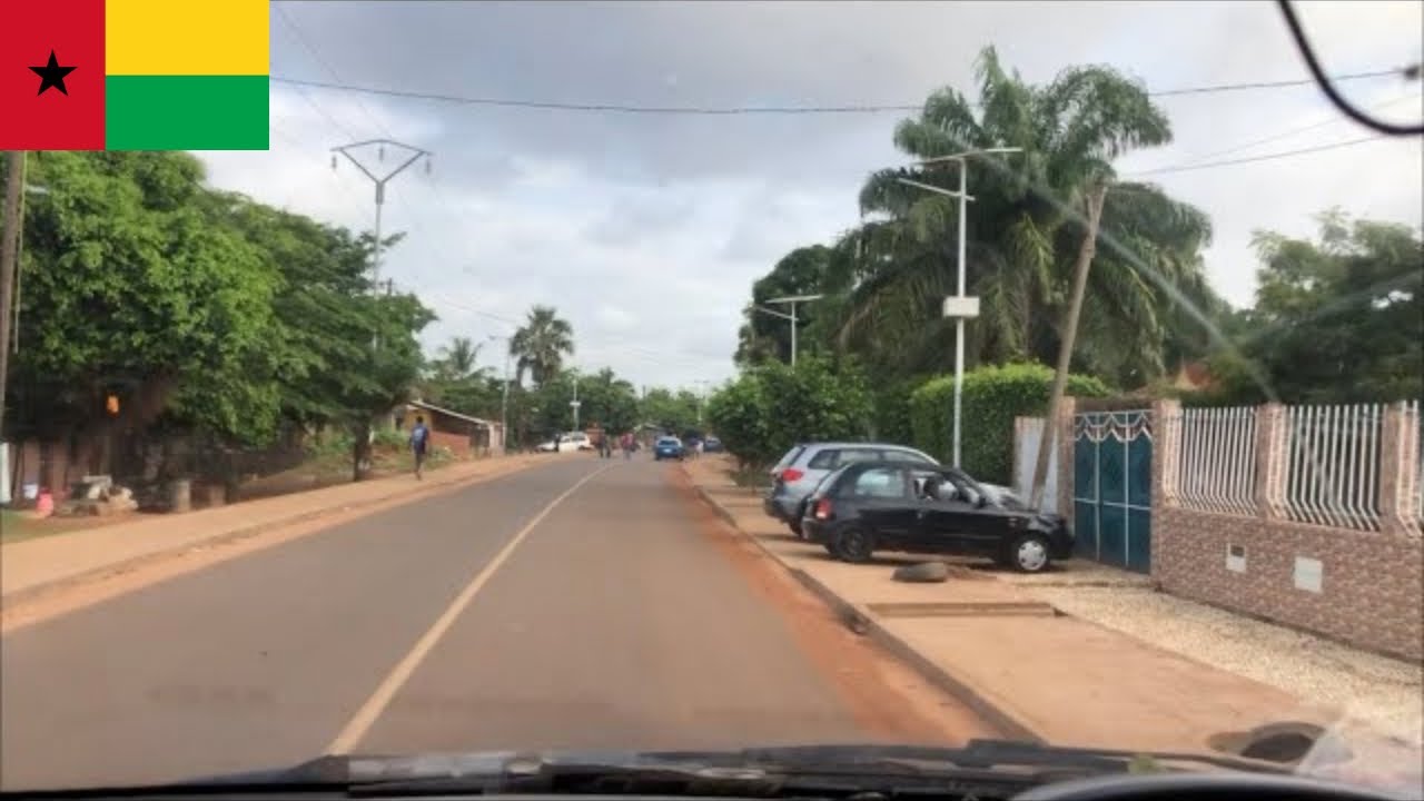 Riding to work across a newly built road in Bissau