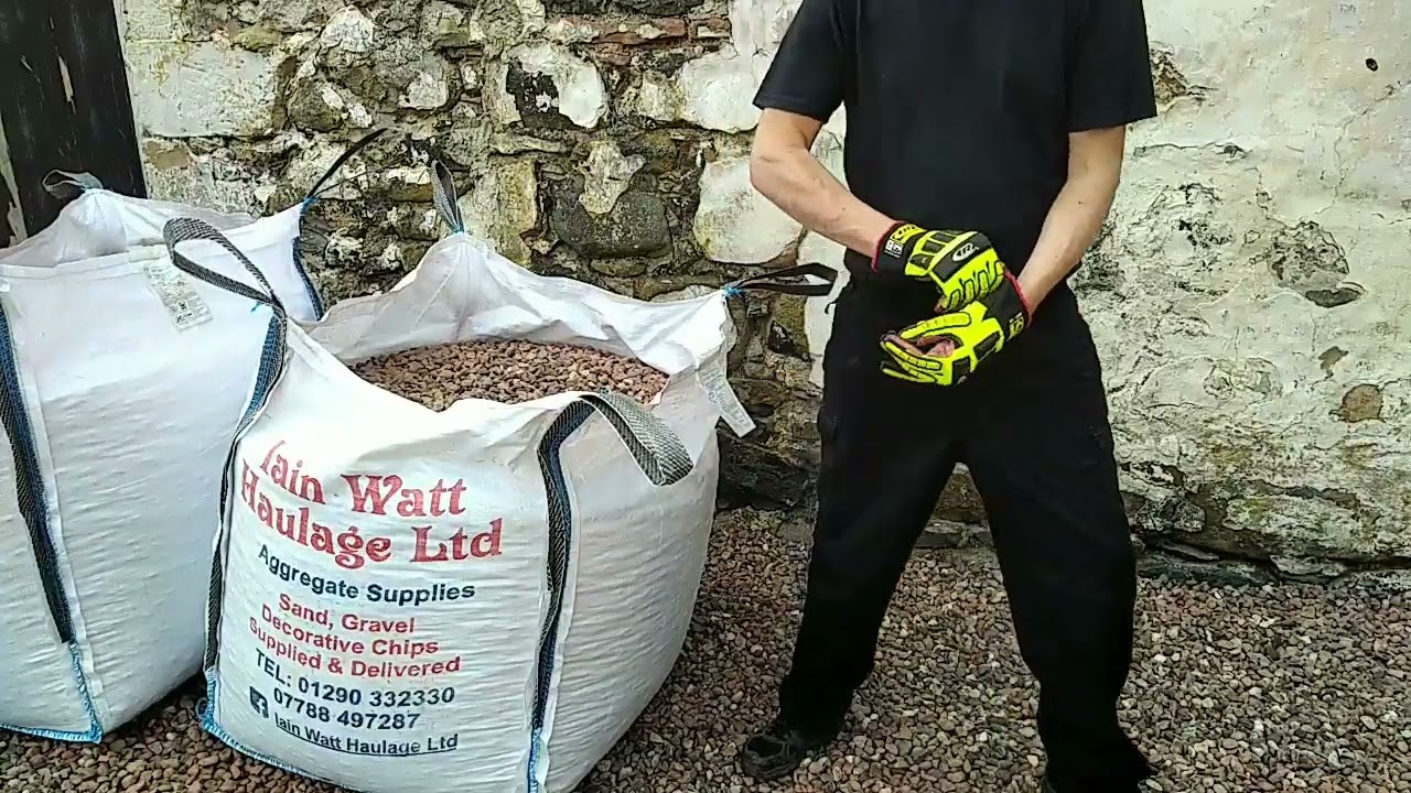 Shovelling stone from a bulk bag. Cut the bag.