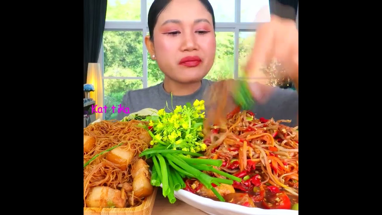 Eating spicy papaya salad with fermented fish sauce, stir fried noodles with pork belly,