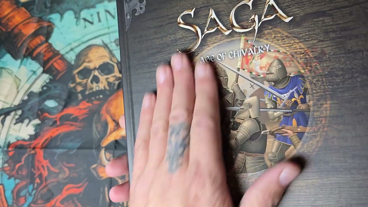 unboxing/flip through of saga age of chivalry from studio tomahawk