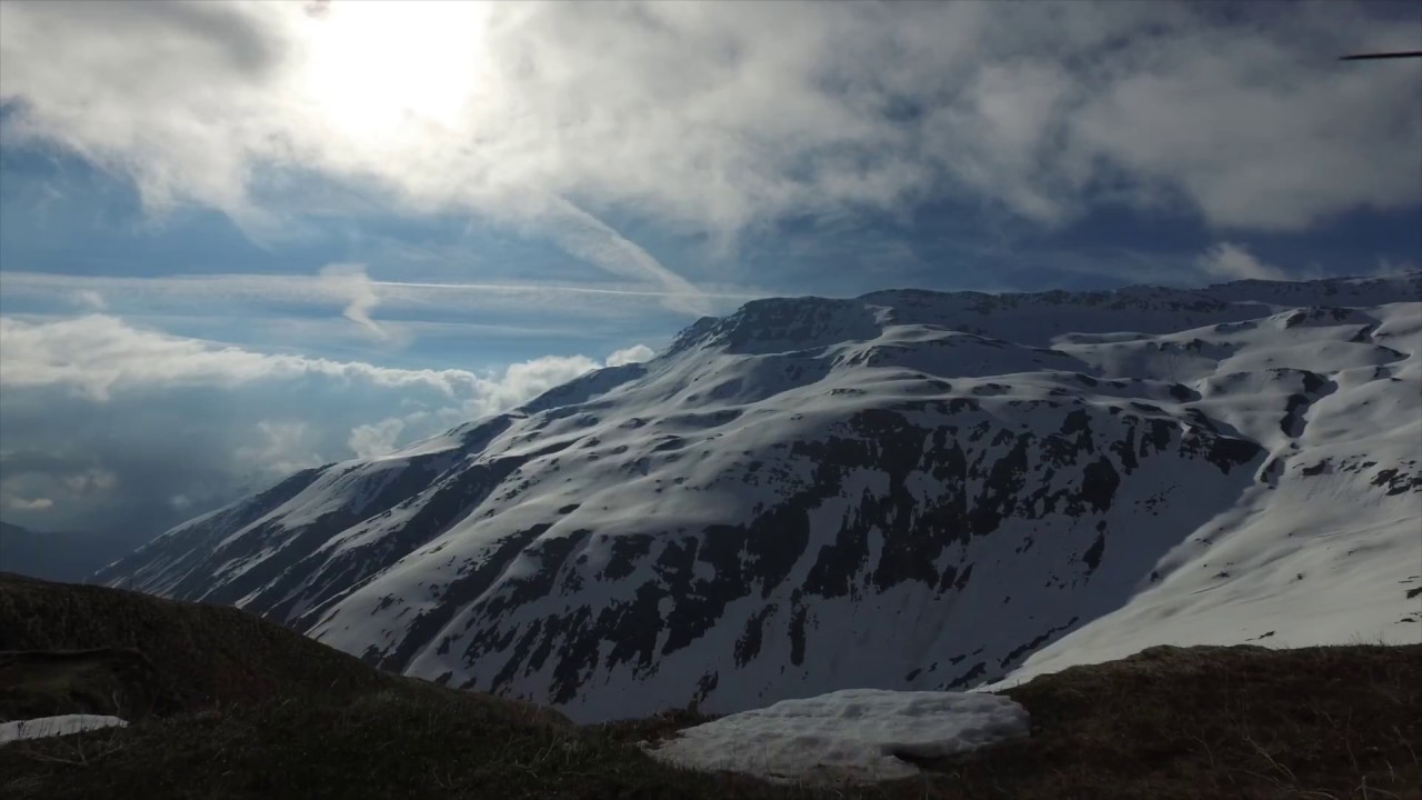 Flight above the clouds on the Furka, a great Swiss summit, drone video