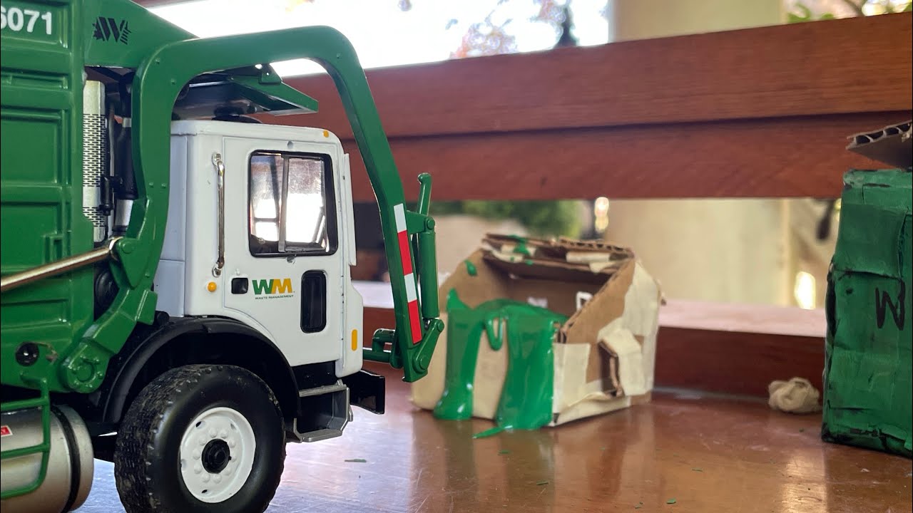 First gear garbage truck picking up a dumpster of paint Hopper View￼￼