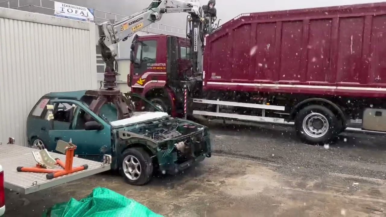 Camion grue qui débarrasse une subaru