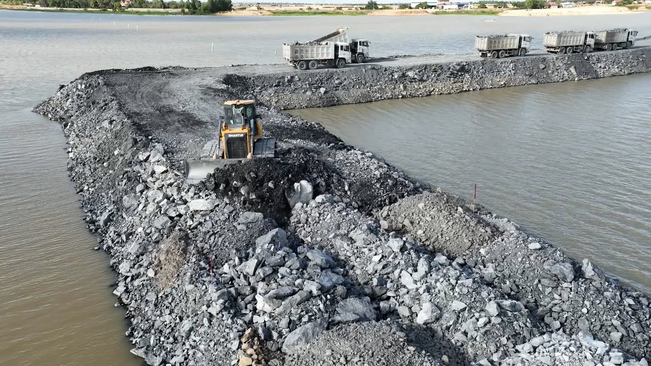 Nice Incredible Action Develop New Road on Big Lake by SHANTUI Bulldozer Pushing Rock , truck Unload