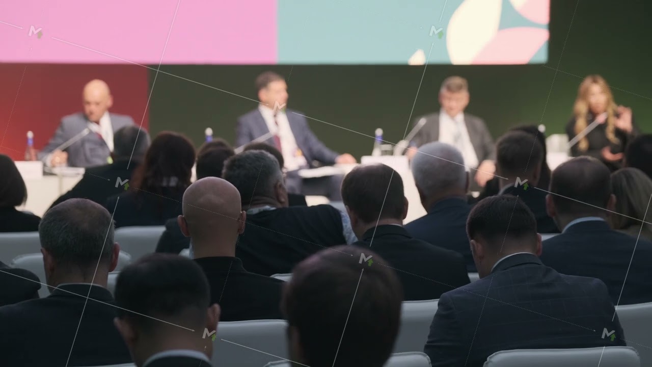 Audience attending panel discussion at formal business conference event