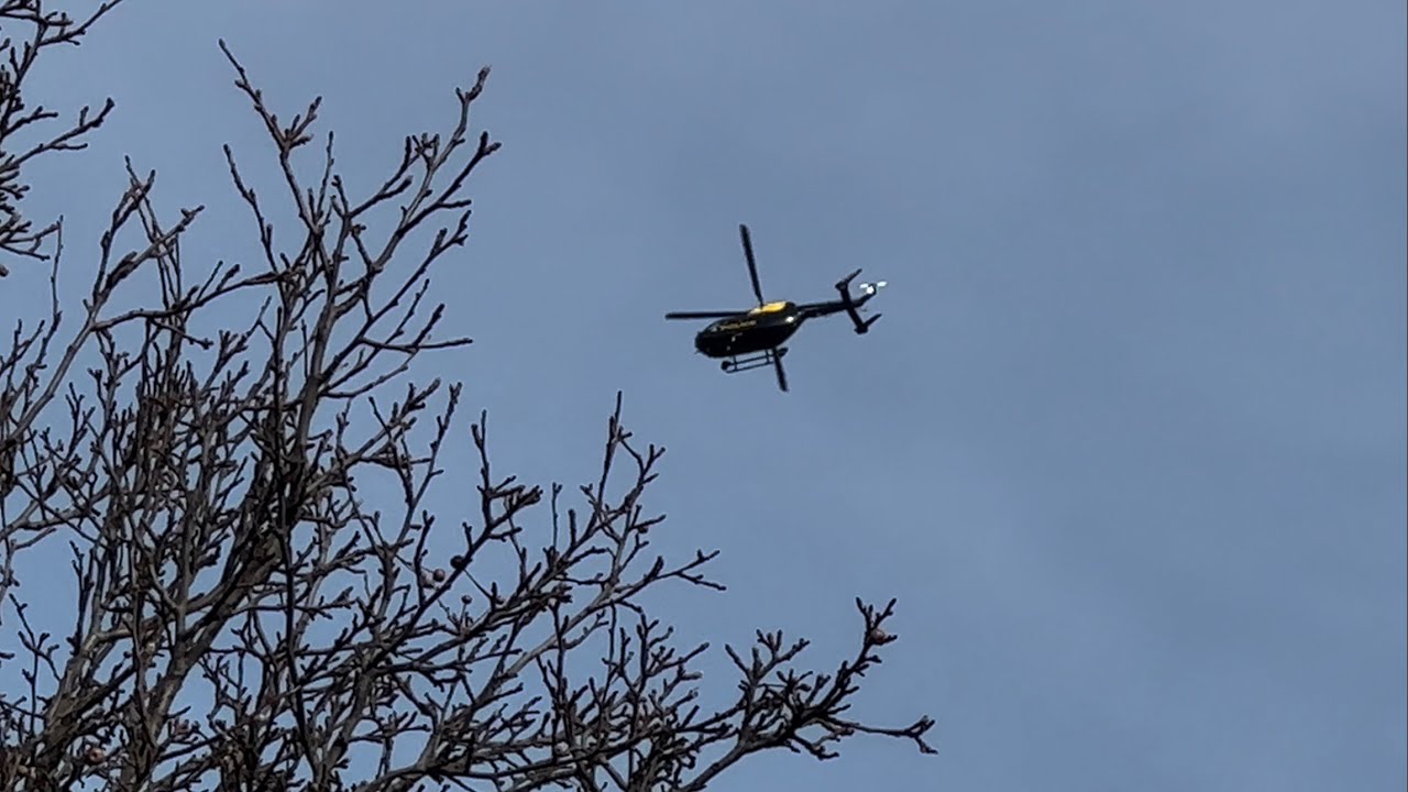 National Police Air Service EC145 helicopter circling above the neighbourhood