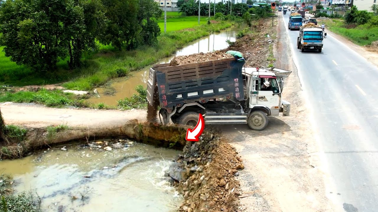 Great start project landfill building road by dump truck unloading soil and Bulldozer D31P pushing 