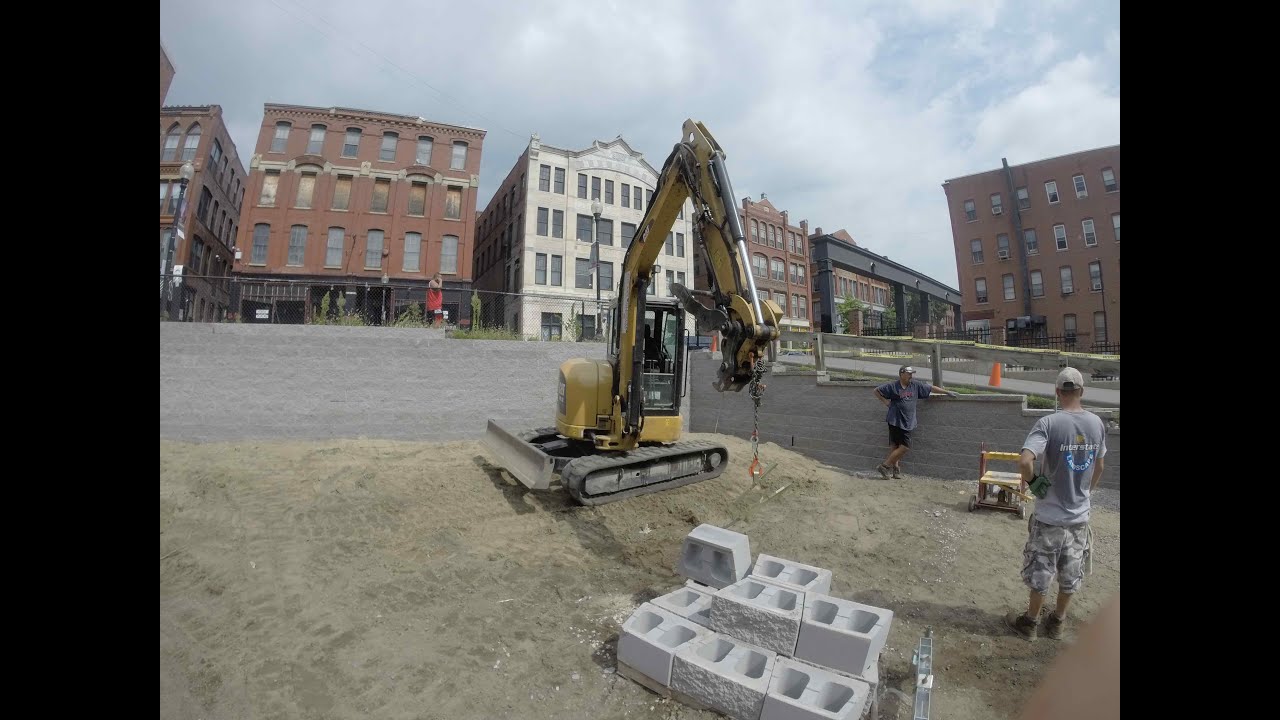 Cat 305.5E2 Excavator Setting Wall Block