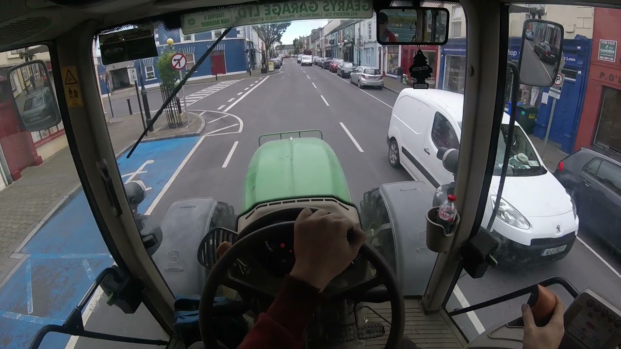 JD 6430 Drawing Silage through the town