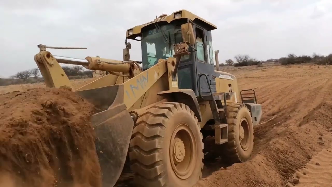 digging a water pond with loader