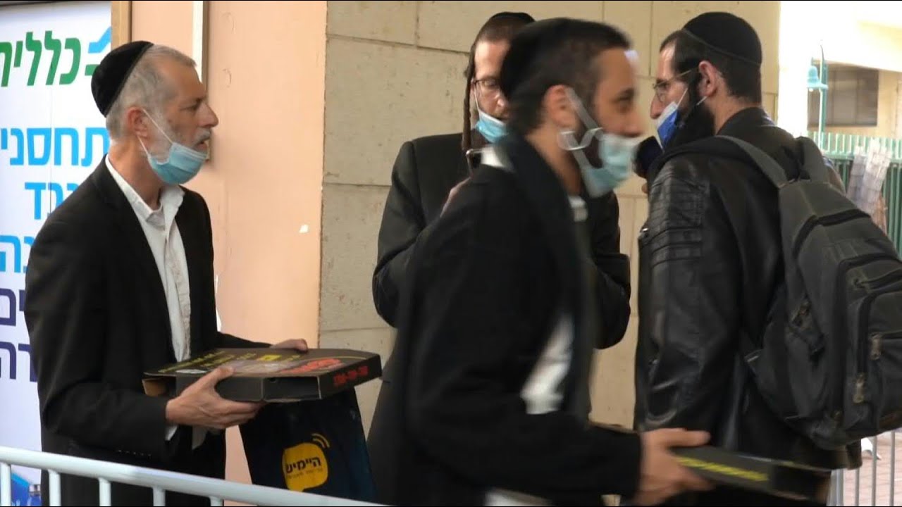 Israeli Ultra-Orthodox Jews receive pizzas after Covid vaccination | AFP
