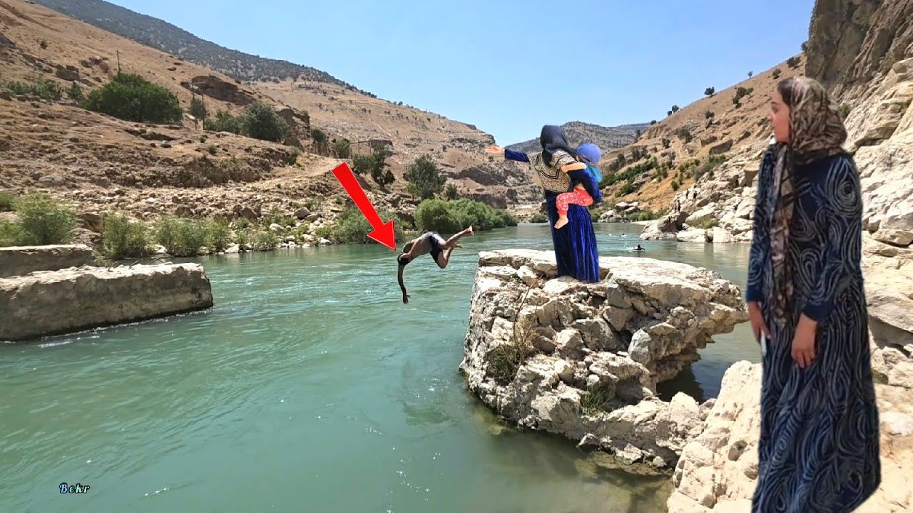 Family trip to a tourist area🏊&zwj;♂️ featuring a tall waterfall: a challenging swim in the river.