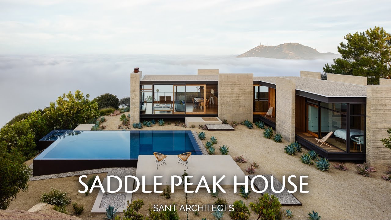 Concrete Walls Emerge from the Terrain Forming Plates that Structure this Mountain Home
