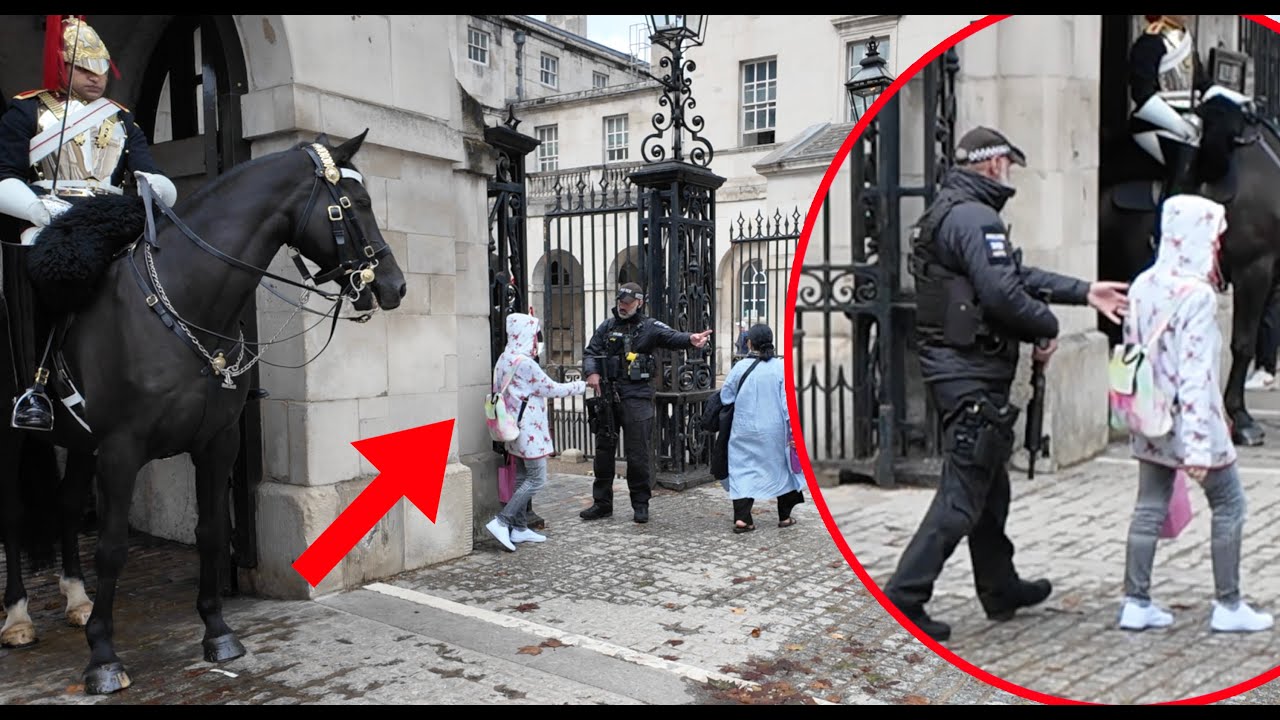 Crowds Watch as Armed Police Escort Her Out. 