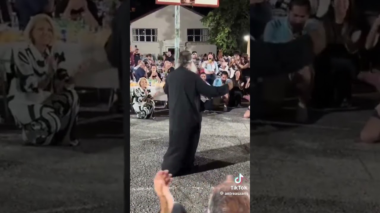 GREEK Orthodox PRIEST joyfully dancing, embodying the spirit of GREEK heritage.