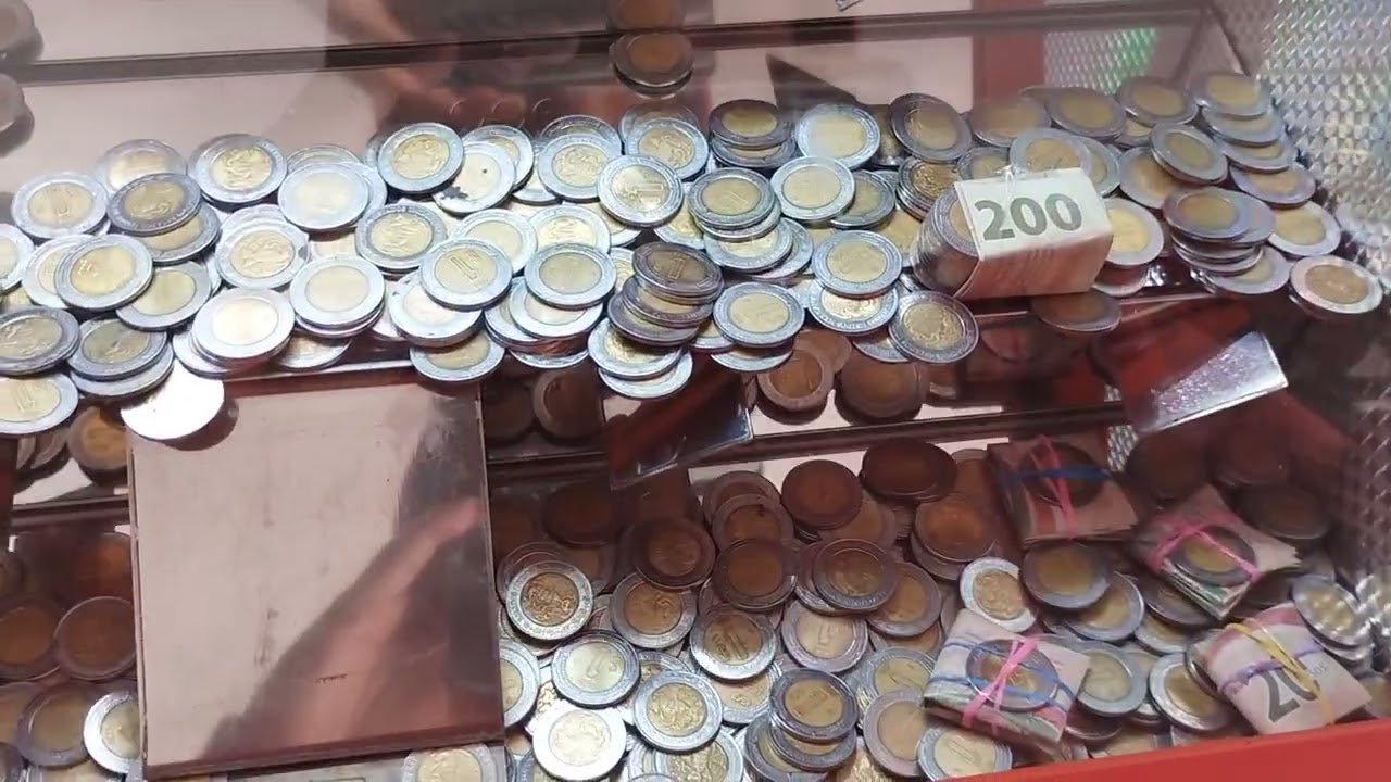Jugando $20 A la Cascada de monedas de 1 peso 
