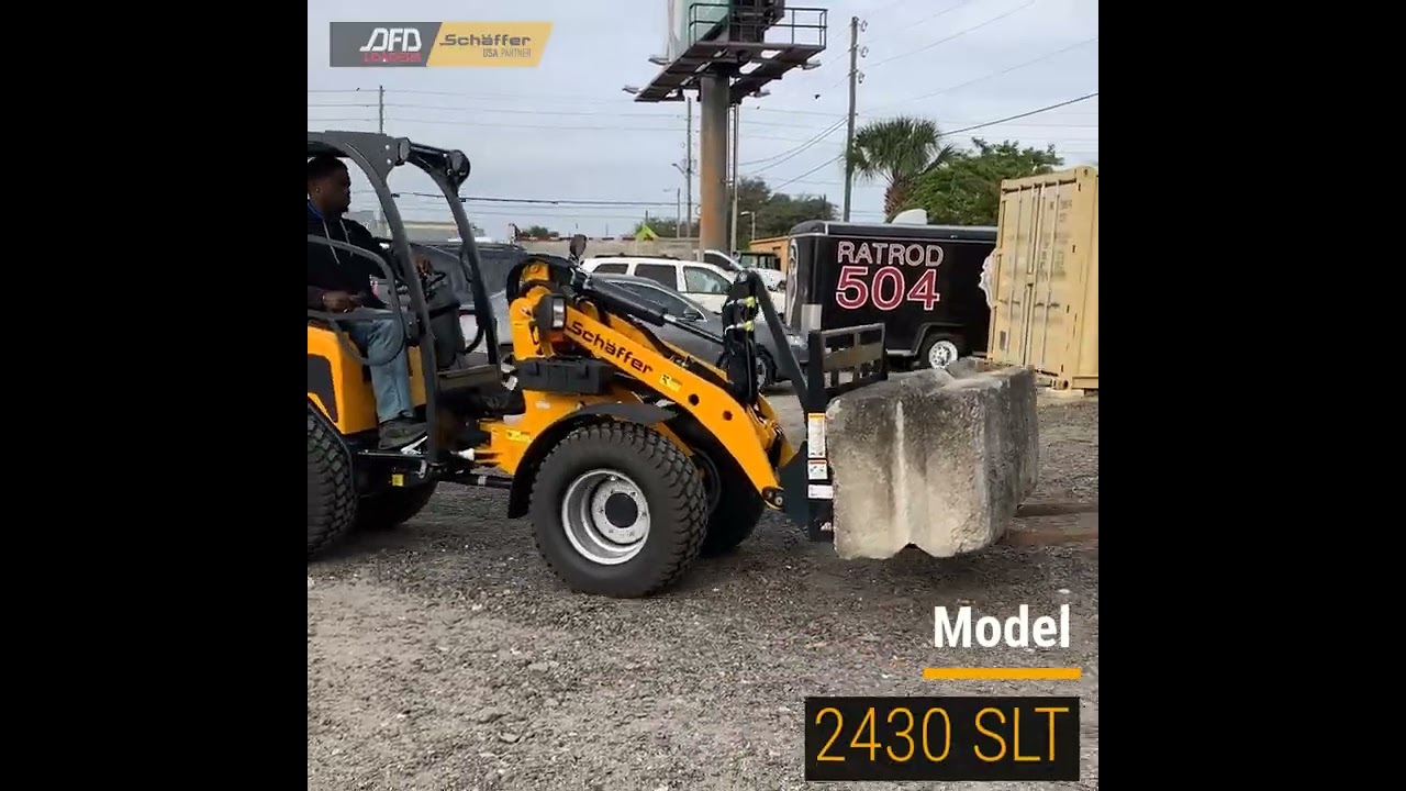 Schäffer 2430 SLT With Pallet Fork Bucket In Action