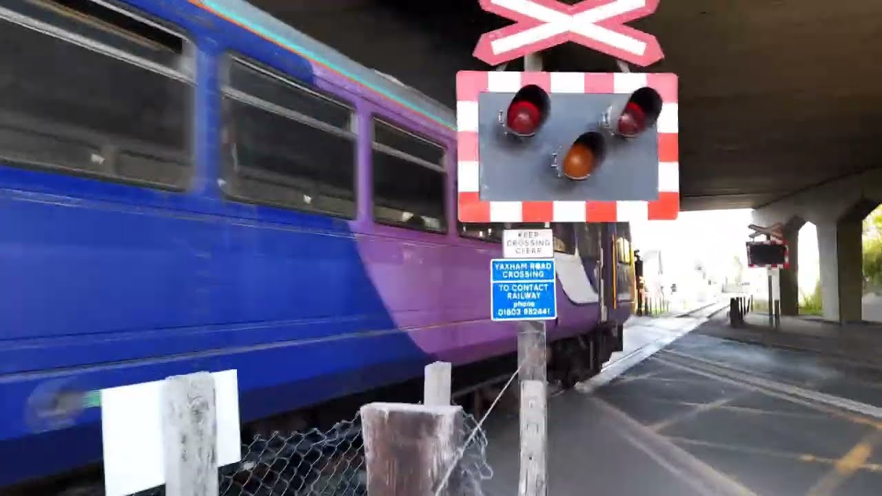 Ex Northern 142061 passing through Yaxham Road level crossing on the Mid-Norfolk Railway 15/10/2022