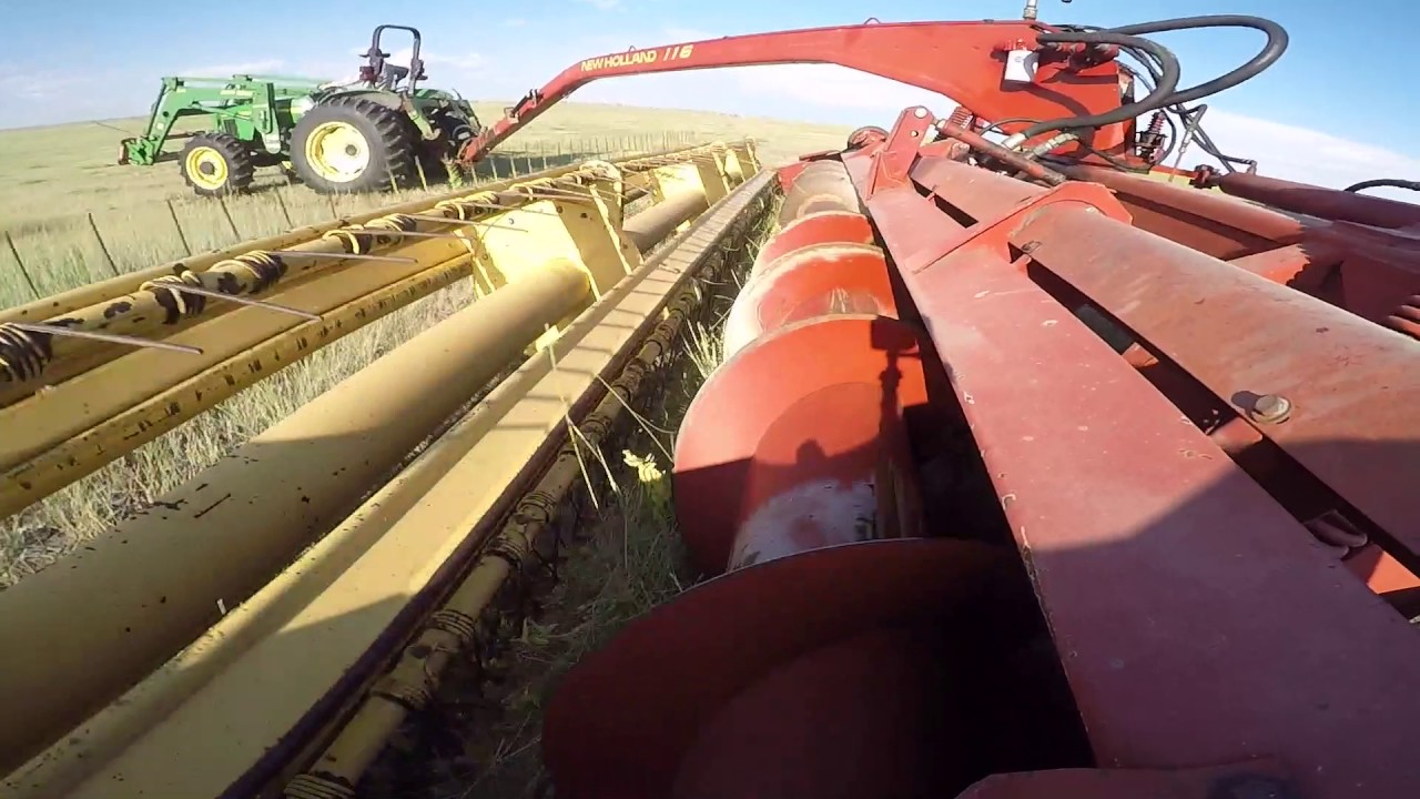 John Deere 5320 making hay with a New Holland 116