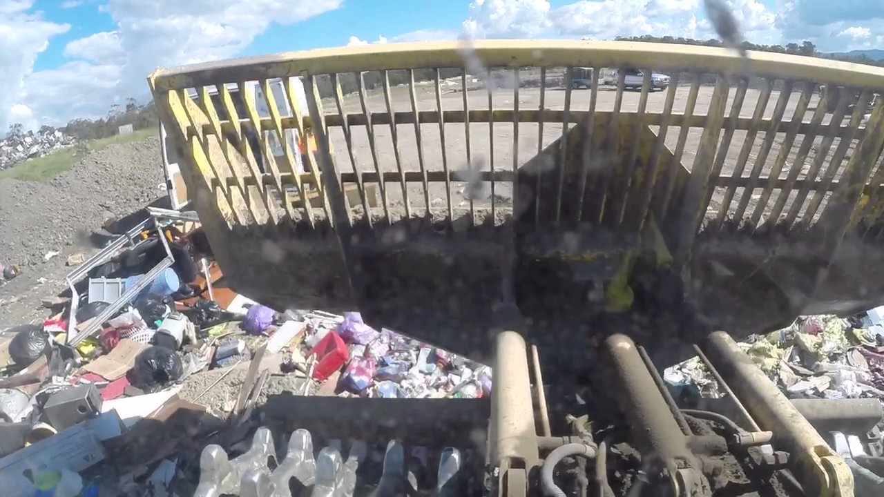 Crushing rubbish in a Bomag refuse compactor