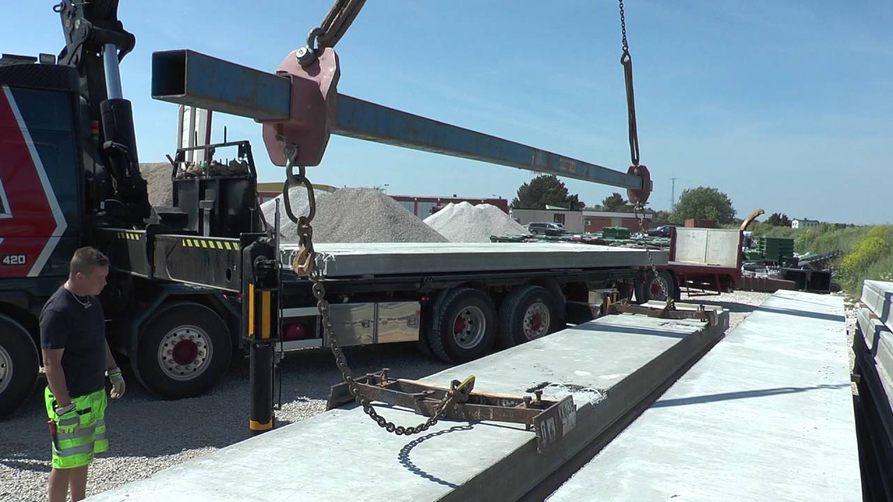 Volvo truck with a crane used for heavy lifting of concrete elements to a building outside the city