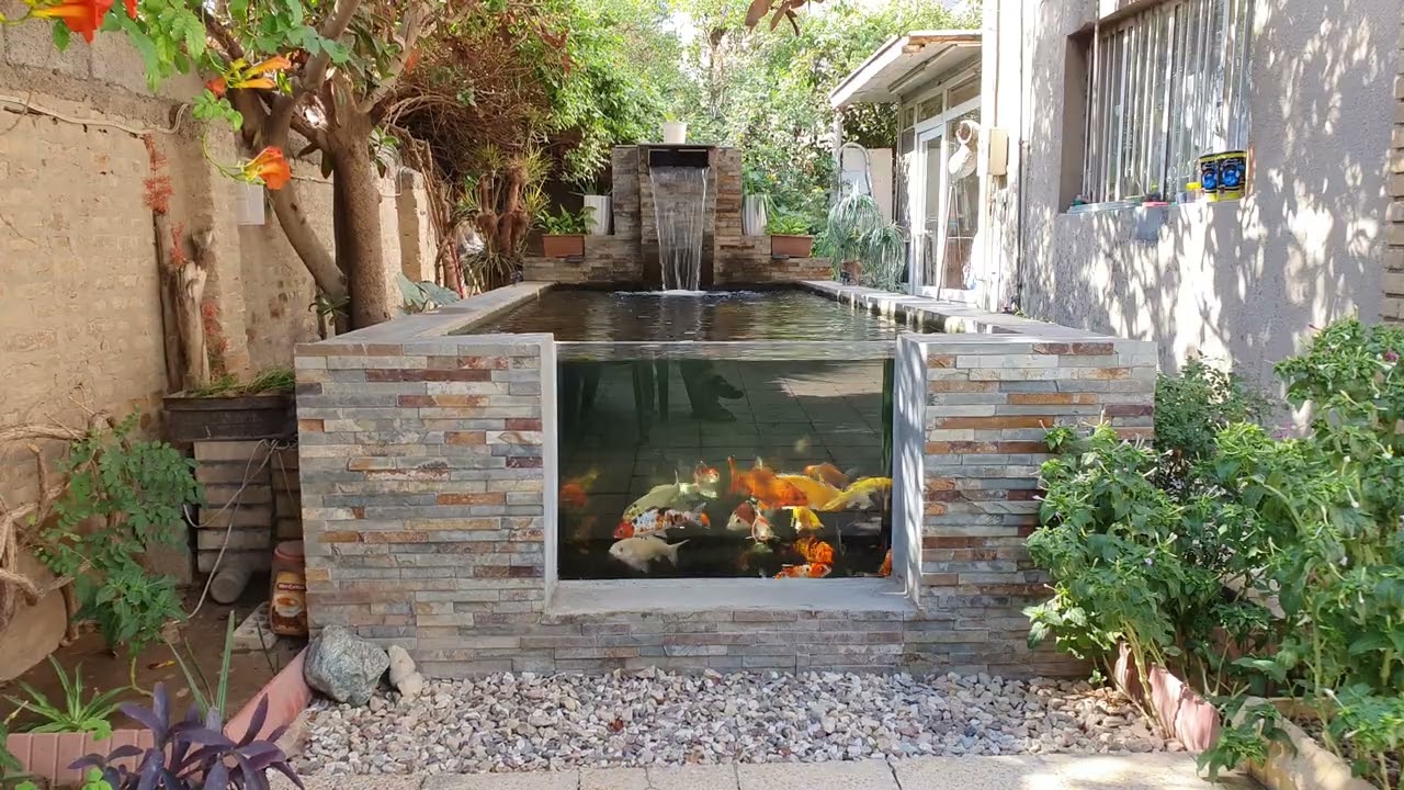 8000 liter Koi pond with chamber filtration and blade waterfall. 1 meter pond window.