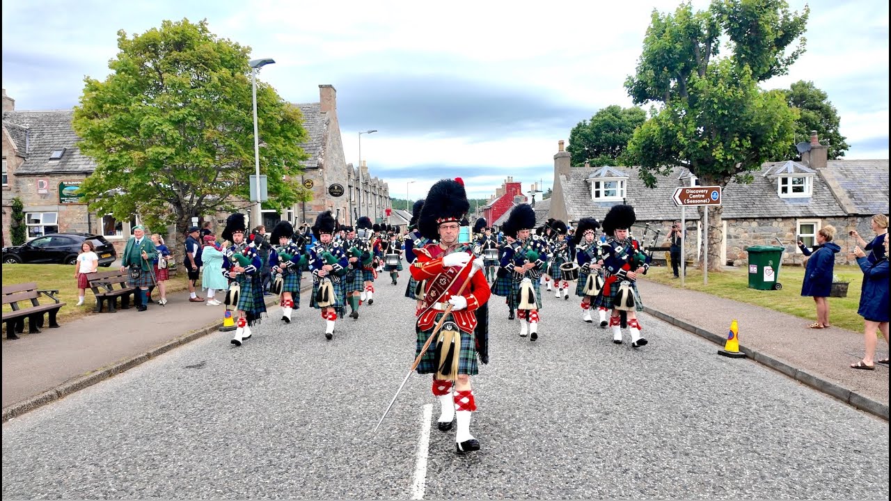 Drum Major leads Ballater Pipe Band march into Tomintoul before the 2025 Highland Games in Scotland