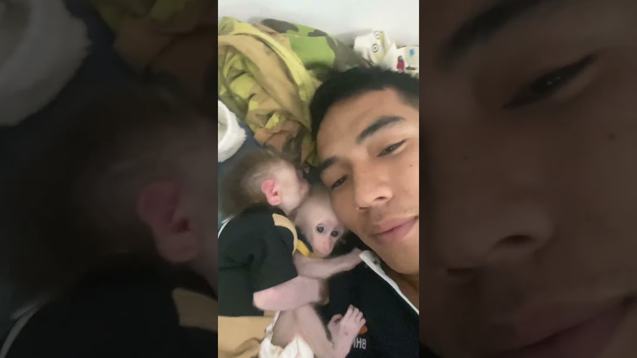 two babies hugging dad sleeping