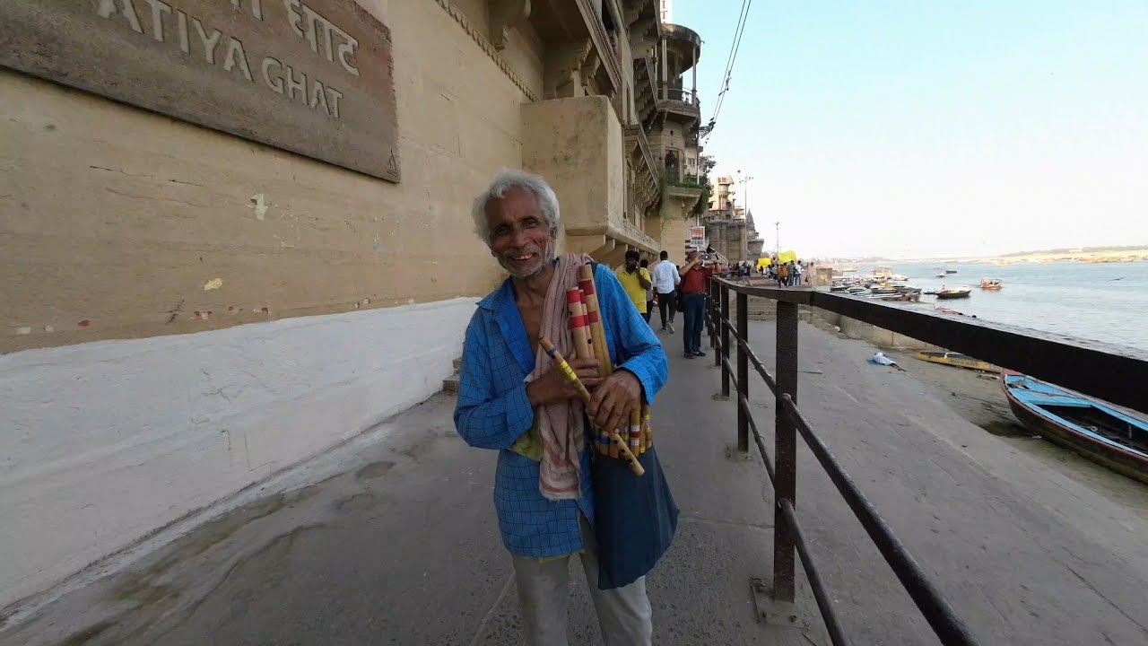 Flute seller at Varanasi Ghat plays 